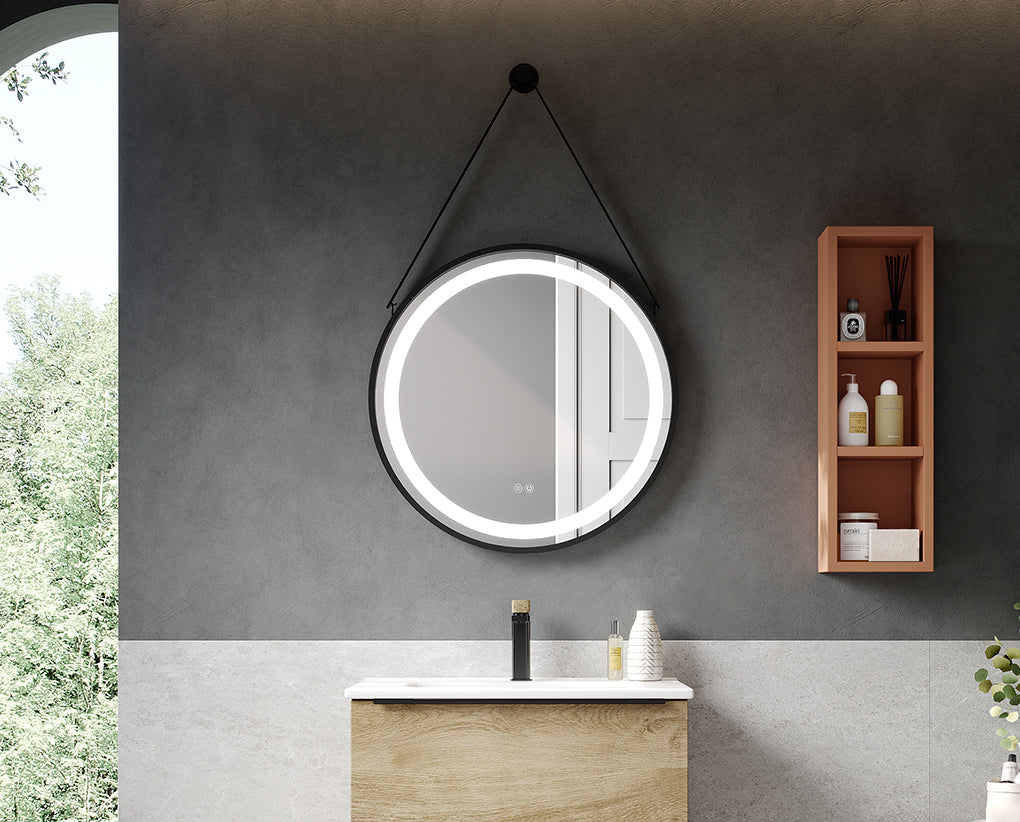 Bathroom with round illuminated mirror, wooden shelf, and sink.