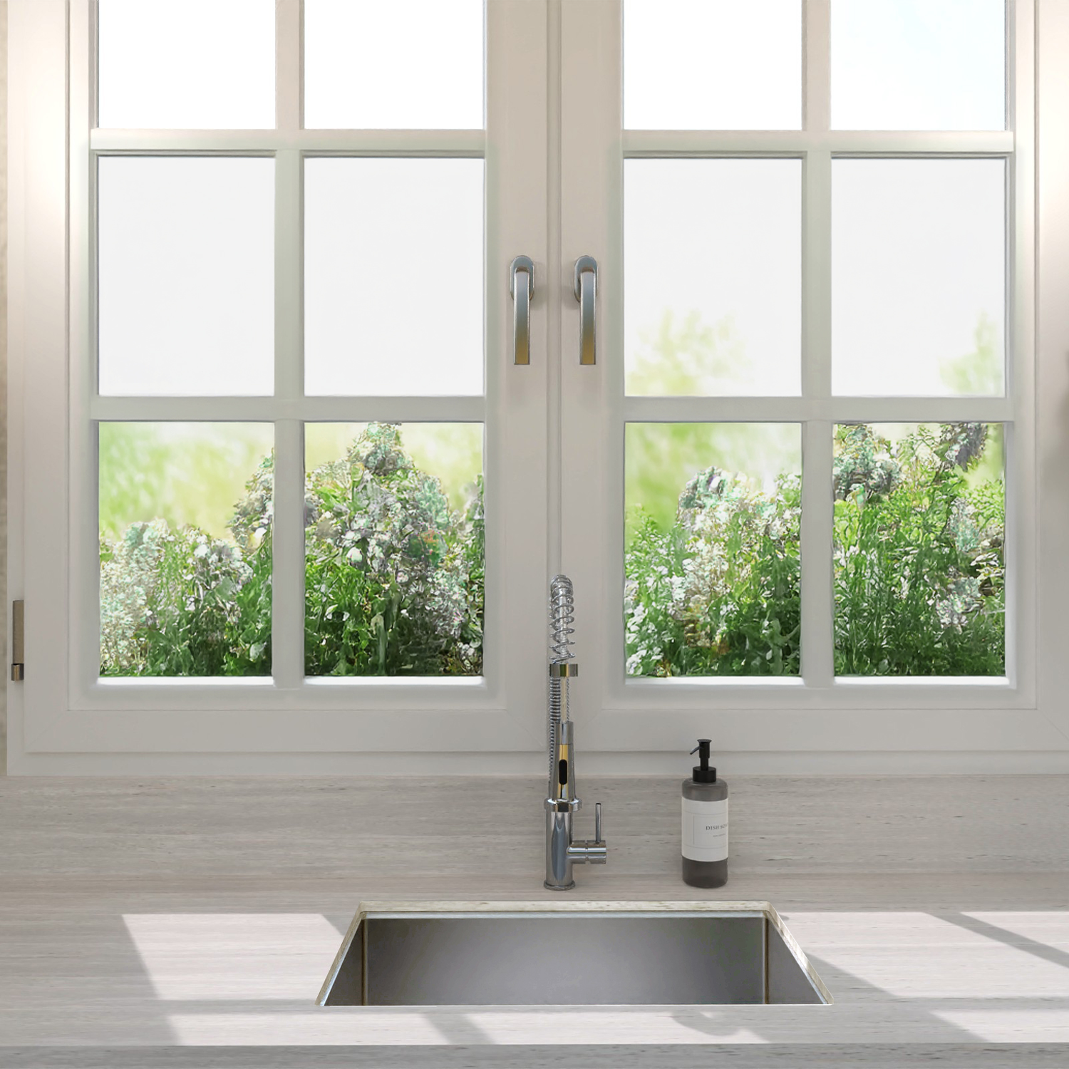 Modern kitchen sink with faucet in front of a large window with a view of greenery