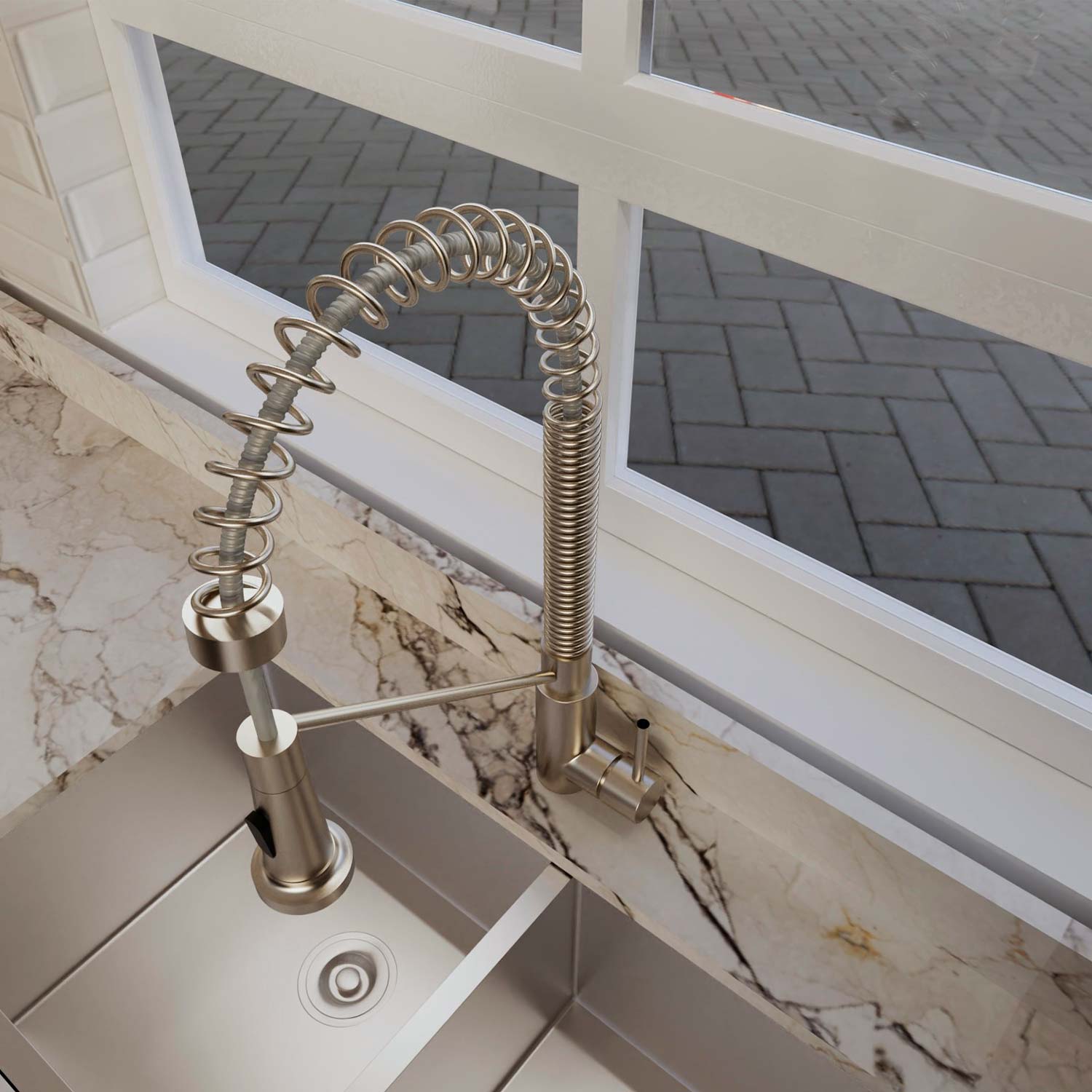 Modern kitchen faucet with a flexible hose on a marble countertop.