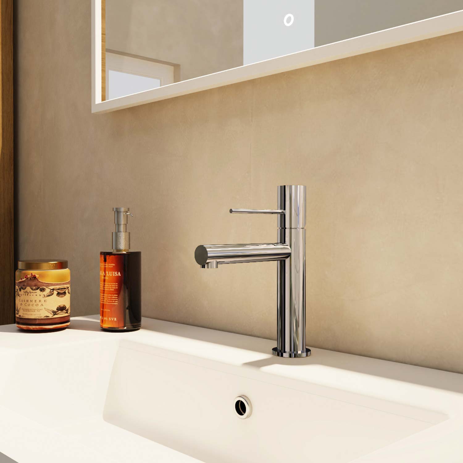 Modern silver faucet on a bathroom sink with a candle and bottle in the background.